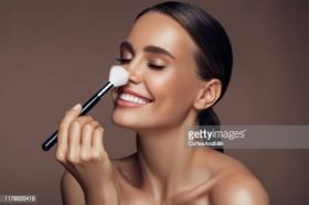 Beautiful woman applying make-up